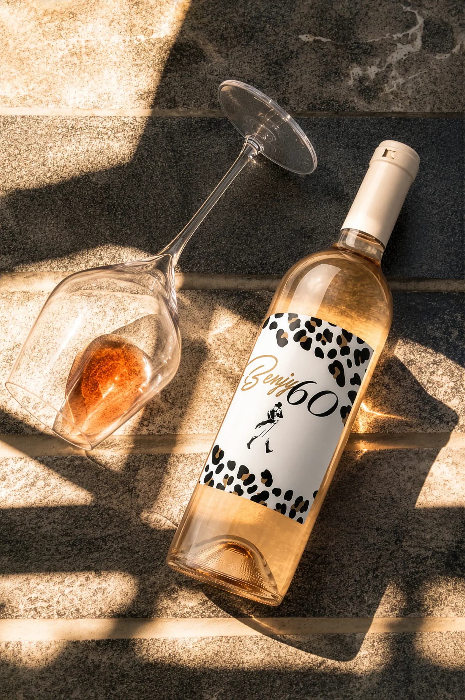 Benjy 60 rosé bottle in hard sunlight on stone